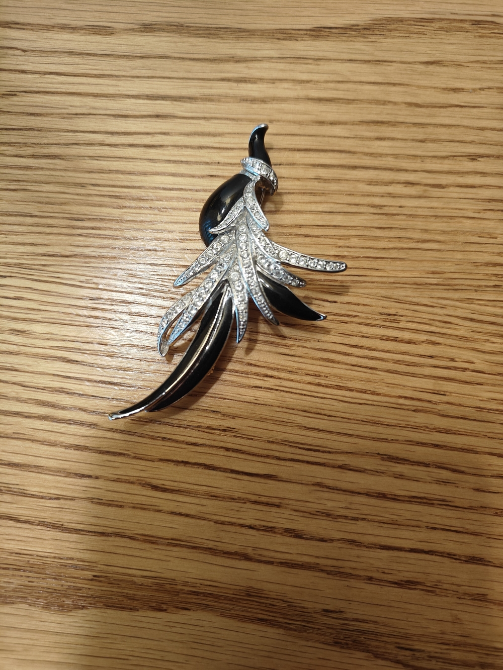 Nolan Miller black bird brooch featuring black enamel and clear Rhinestones